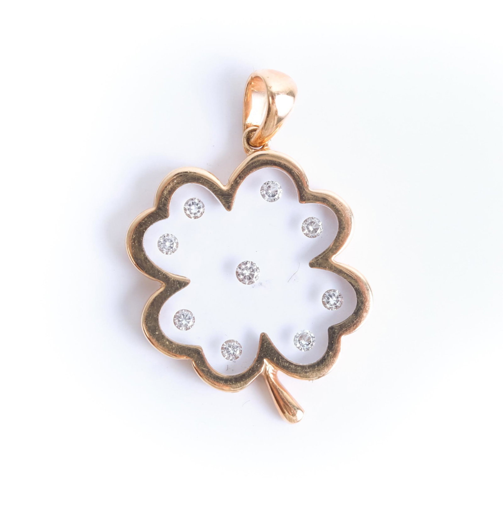 18K Yellow Gold Diamond 4 Leaf Clover Pendant: 18K yellow gold four leaf clover pendant with nine diamonds (0.08tdw). Stamped 18K. Approx. overall length .87", weight 1.42 grams.