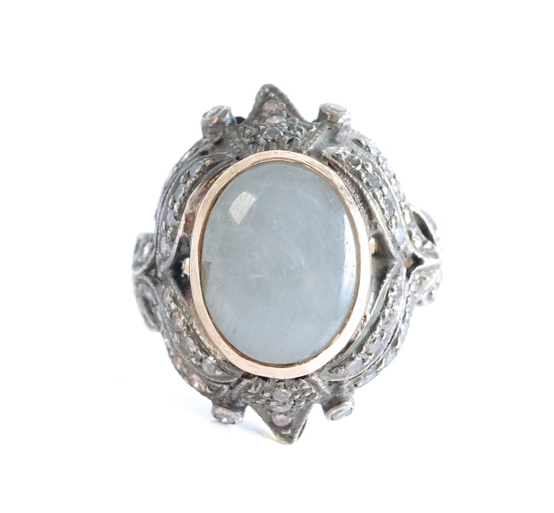 Vintage 18K & Sterling Silver Moonstone Ring: Vintage 18K and sterling silver ring having an inset moonstone surrounded by small diamonds. Ring marked 18K and .925. Size 6 1/2. Approx. overall weight 7.75 grams.