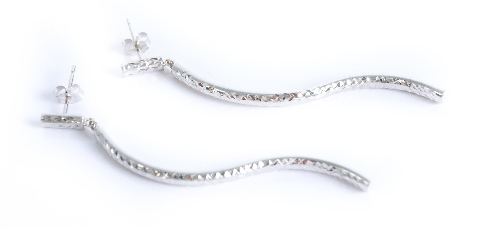 14K White Gold S-Shaped Chiseled Post Earrings: 14K white gold S-shaped post earrings having a chiseled decoration. Stamped 14K. Approx. length 2.25". Approx. weight 1.63 grams.