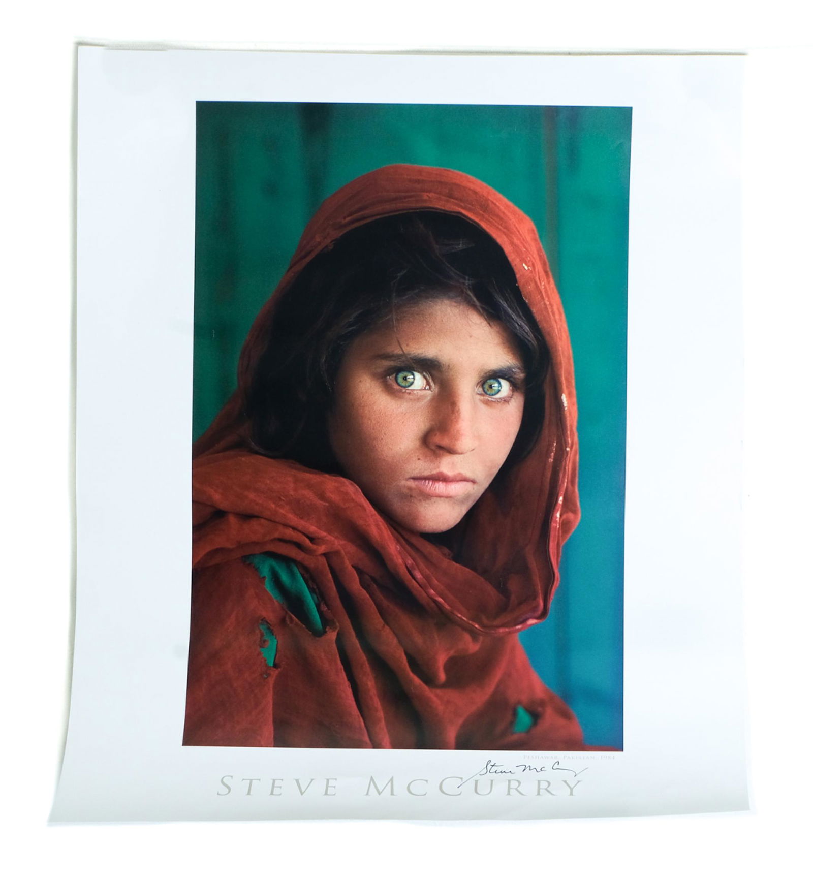 Steve McCurry, Afghan Girl, Lithograph Signed: Steve McCurry (American, b. 1950), Afghan Girl (Sharbat Gula), offset lithograph in colors, signed lower right in black marker. Unframed approx. 24" x 20".
