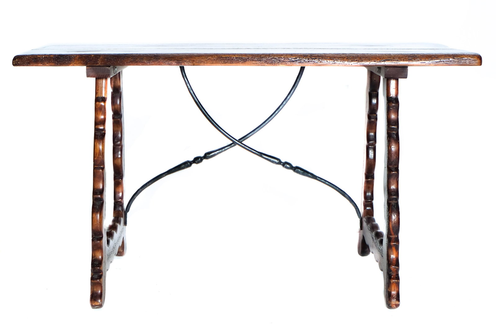 Spanish Baroque Style Hall Table: 20th century Spanish Baroque style hall or refectory table having thick board top on scroll carved legs united by a wrought iron buttress. Approx. height 28.5", width 51", depth 25.25".