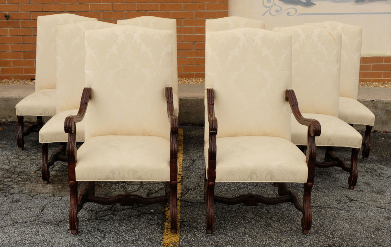 Set, 8 Louis XVI Style Upholstered Dining Chairs: Set of Louis XVI style stained wood dining chairs comprising two arm and six side chairs having serpentine padded back upholstered and joined by downswept arms with scroll and leaf carved supports rai