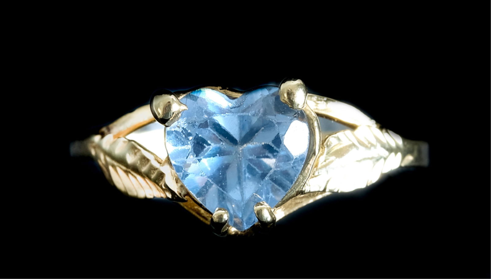 14k Yellow Gold & Heart Shaped Blue Topaz Ring: 14k yellow gold ring with heart shaped blue topaz gemstone. Stamped 14k. Ring size 7. Approx. overall weight 1.51 grams.