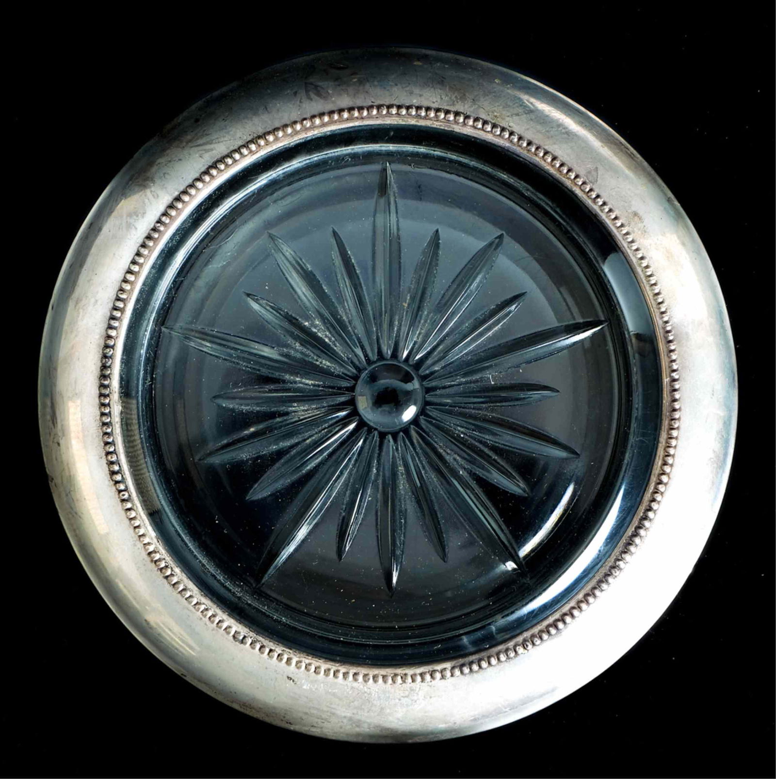 Frank M. Whiting 925 Champagne Wine Coaster: Frank M. Whiting Sterling champagne or wine bottle coaster with starburst glass design on the bottom. Engraved FRANK M. WHITING & CO/STERLING/06/PAT PENDING. Approx. height 1.25", overall diameter 6.7