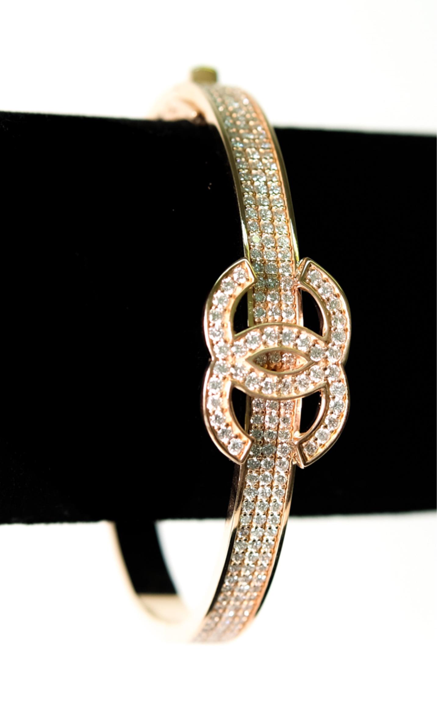 18k Rose Gold Chanel Style CC Diamond Bracelet: 18k rose gold Chanel style CC logo hinged bangle bracelet set with approx. 3.3ctw round brilliant diamonds. Stamped 18k. Approx. interior diameter 2.25 inches. Approx. overall weight 35.2 grams.