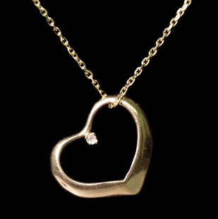14k YG Heart Shaped Diamond Pendant Necklace: 14k yellow gold chain hung with a 14k yellow gold heart shaped pendant centered with a diamond. Pendant and chain stamped 14k. Approx. length of chain 16 in., heart 0.62 x 0.75 inches. Approx. 