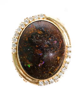 14k YG 15.37 Black Opal & Diamond Ring, size 7: 14k yellow gold ring set with 15.37 oval black Opal and 0.63ctw white diamond accents. Ring size 7. Approx. overall weight 11.5 grams.