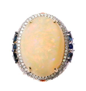 14k YG 22.28 Opal Sapphire & Diamond Ring: 14k yellow gold ring set with 22.28 opal, 3.31ctw diamonds and 2.07 blue sapphires. Ring size 7. Stamped 14k SD. Approx. overall weight 18.53 grams.
