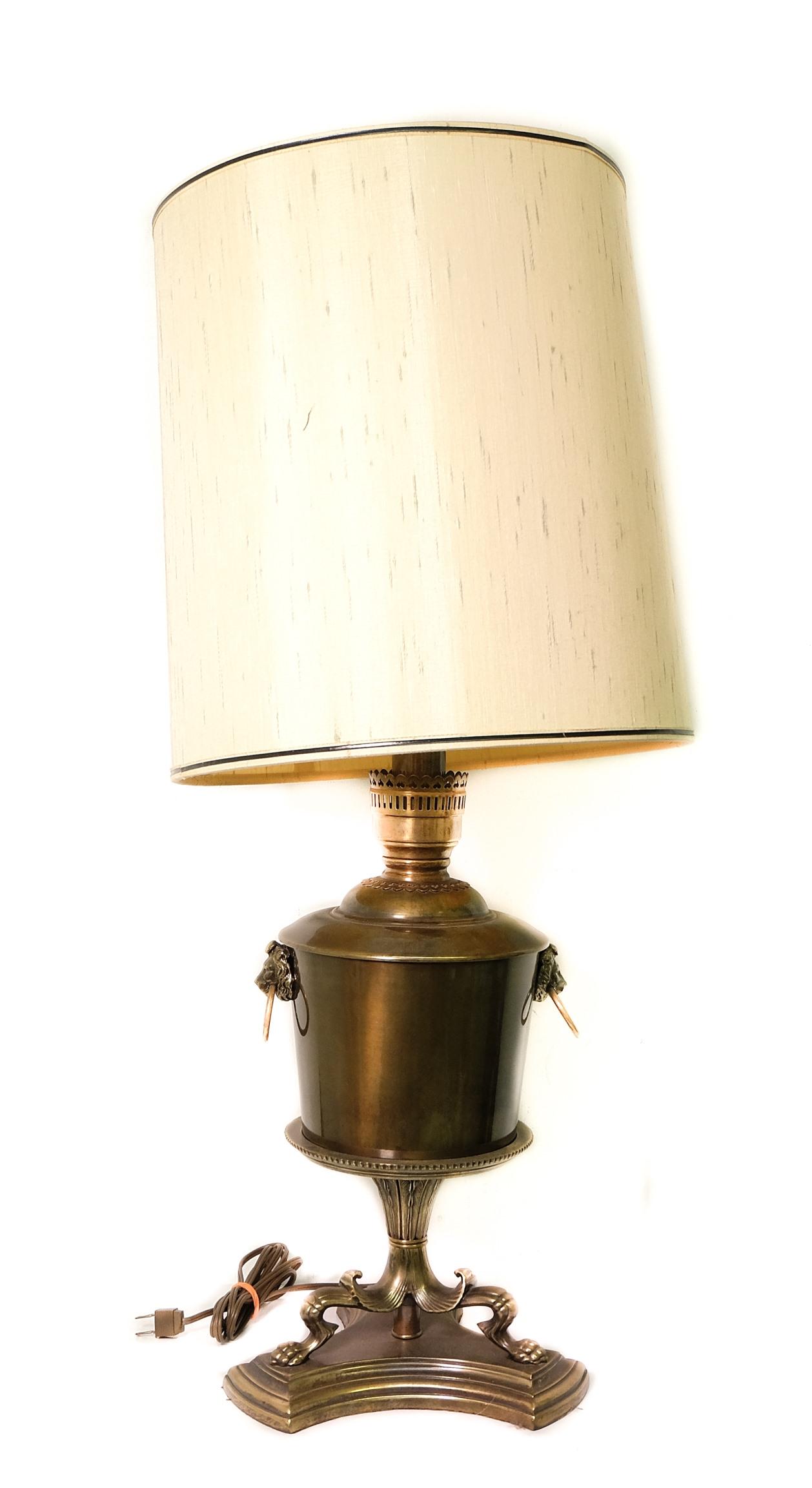 Vintage Frederick Cooper Brass Table Lamp: Vintage Frederick Cooper regency style brass table lamp having the original drum shade. The lamp with lion mask handles on tripartite concave base. Approx. height with shade 32.5 inches.