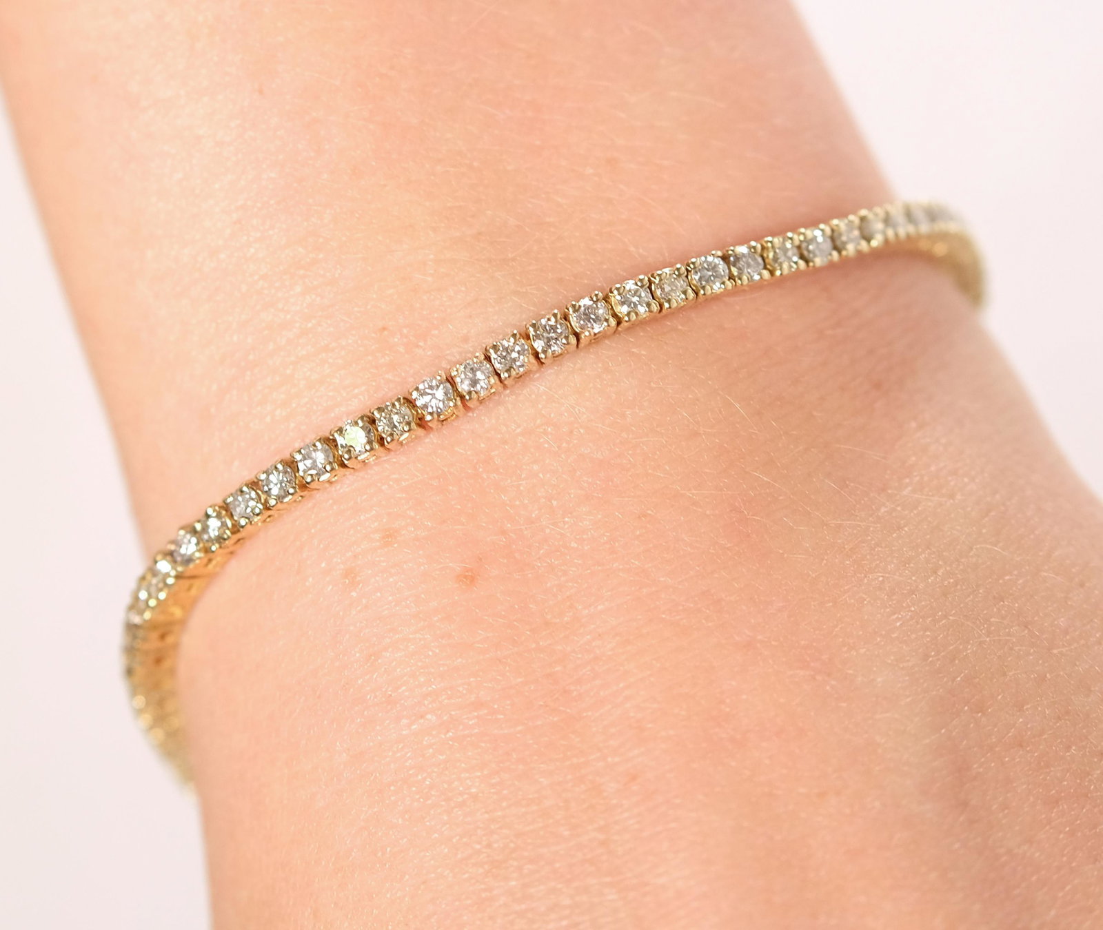 14k Yellow Gold Tennis Bracelet w/76 Diamonds: 14k yellow gold tennis bracelet set with approx. seventy-six round brilliant cut diamonds. Approx. length 8 in., overall weight 12.2 grams.