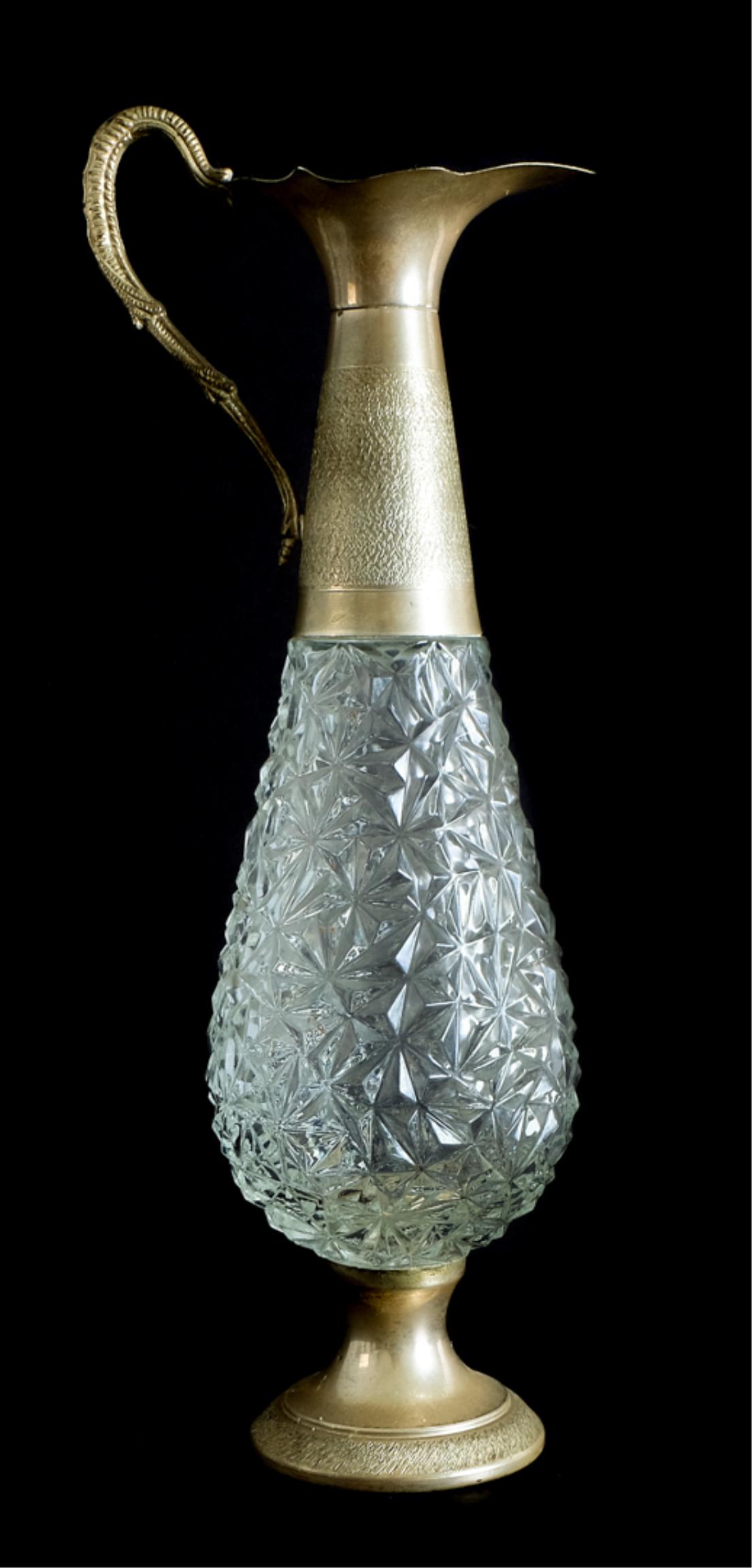 Italian Gilt Metal Mounted Glass Ewer: Italian gilt metal mounted glass ewer with scrolled handle on turned foot. Sticker to base. MADE IN ITALY. Approx. height 14.62" (handle).