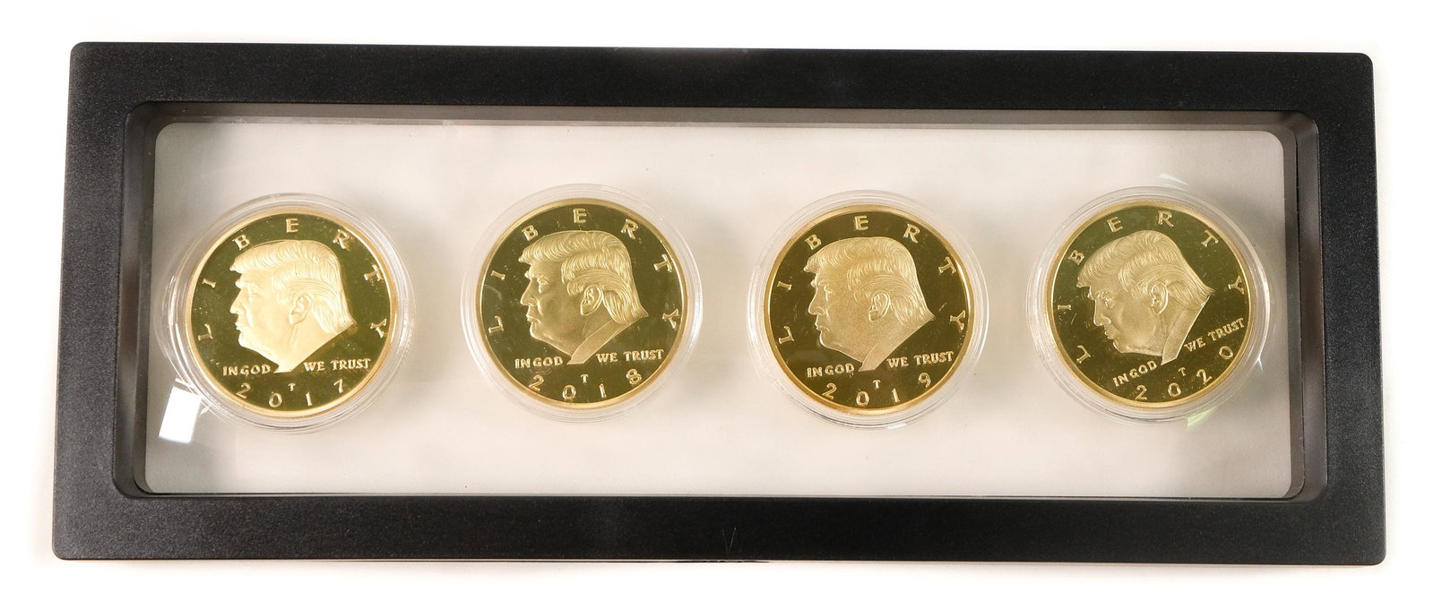 Set, 4 Gold Plated Collectible Donald Trump Coins: Set of 4 gold plated 2017-2020 collectible Donald Trump coins encased in a plastic plaque. Plaque measures approx. 9in.