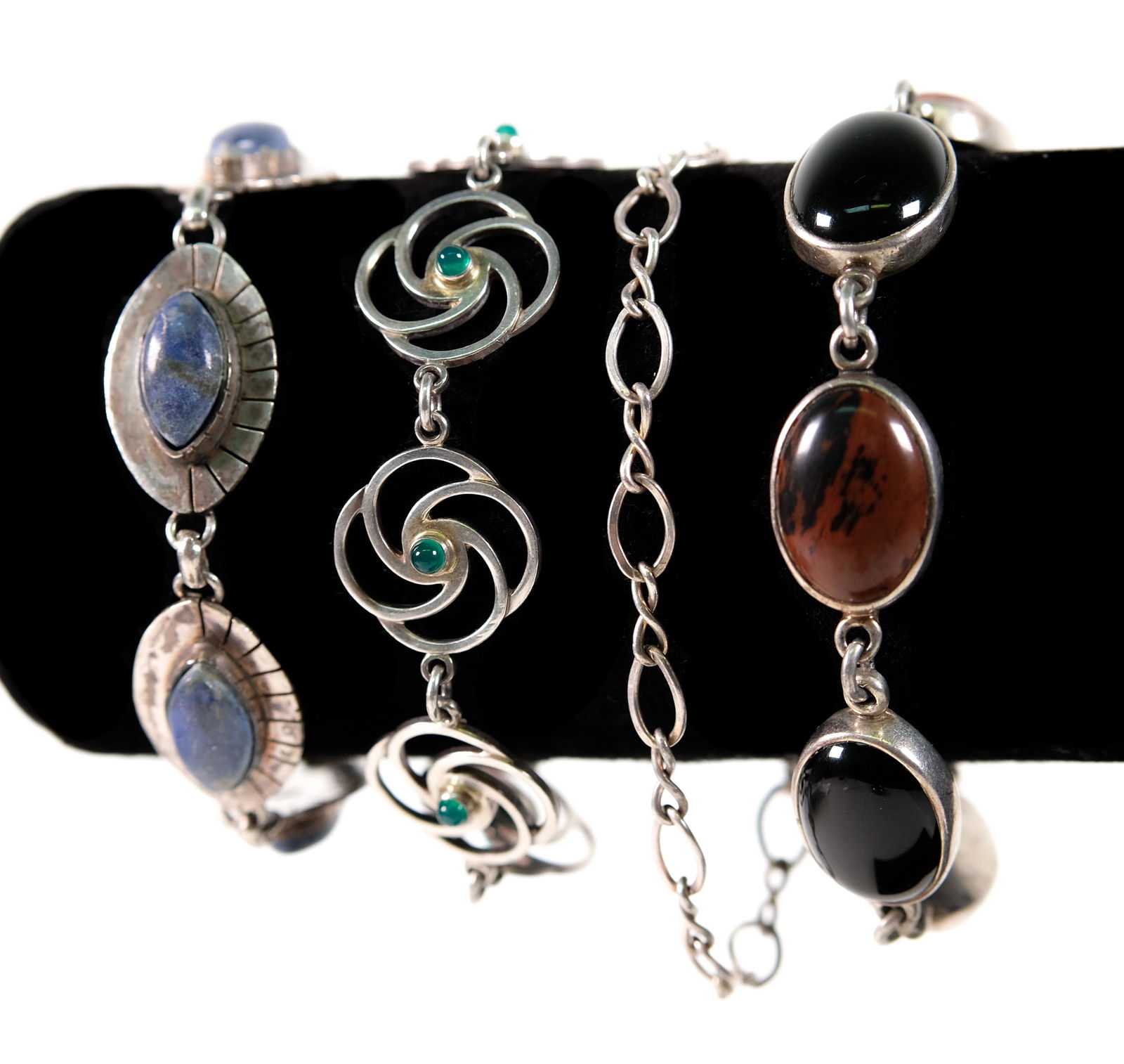 Group, 4 Sterling Silver Link Bracelets: Grouping of 4 sterling silver link bracelets, most with gemstones. All stamped 925. Approx. lengths 7.5in to 8in. Approx. overall weight 66 grams.