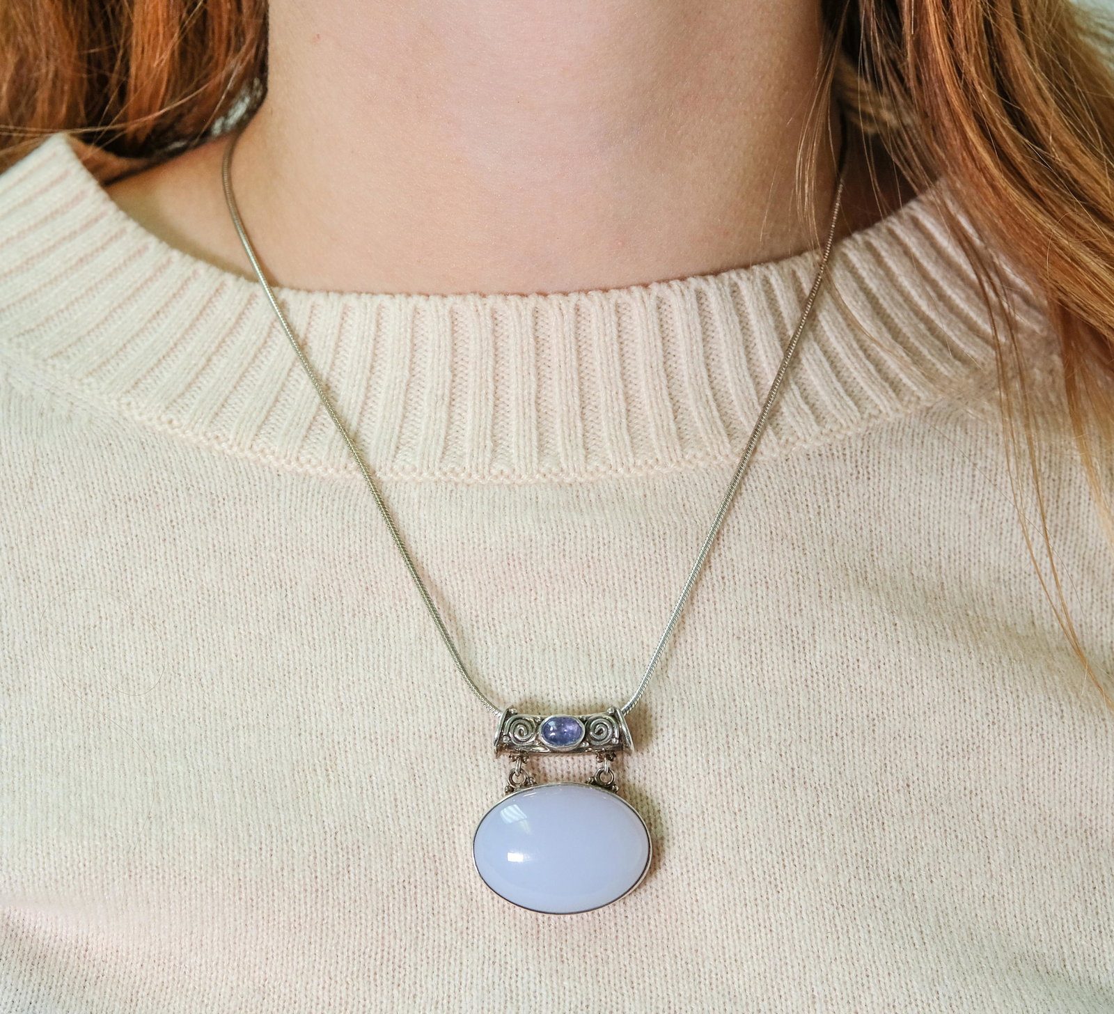 Sajen Sterling Silver Iolite Pendant Necklace: Sterling silver chain hung with a Sajen sterling silver pendant having two cabochon iolite stones. Chain stamped 925, pendant Sajen 925. Approx. chain length 16in., pendant 1.25in.