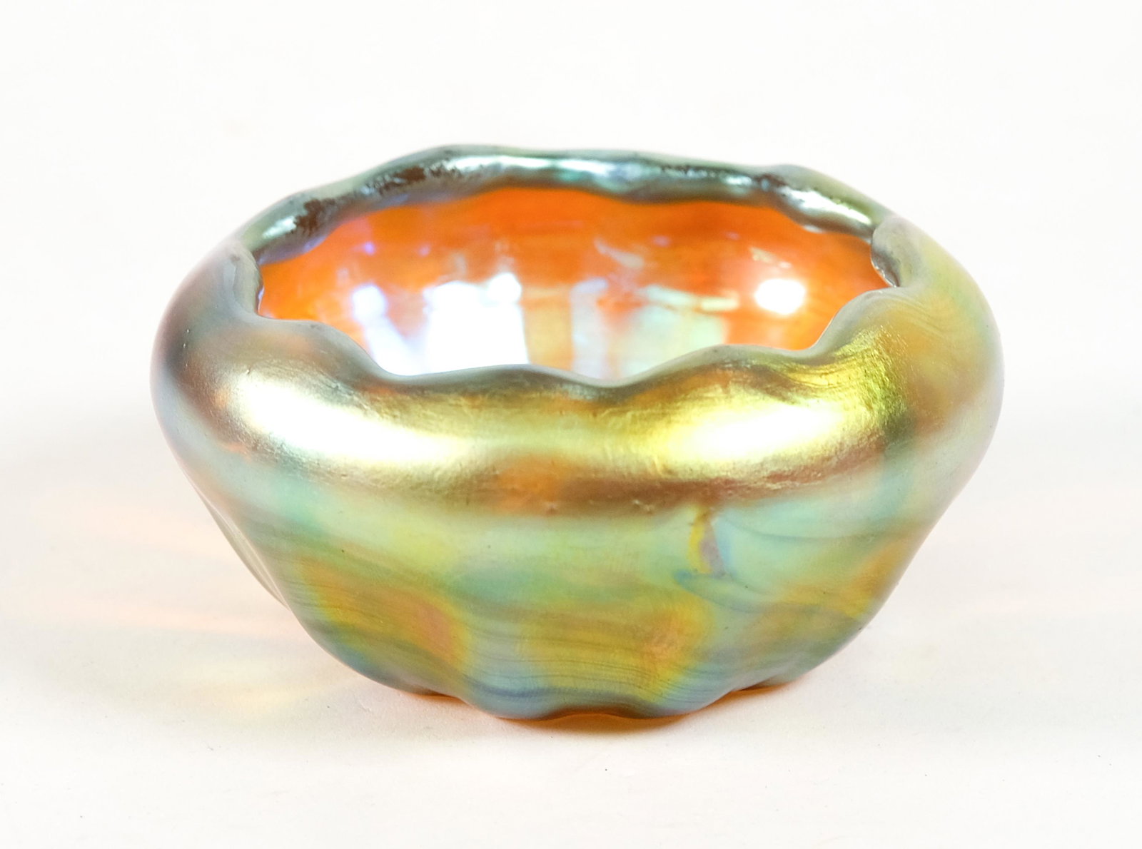 Steuben Gold Aurene Glass Open Salt: Steuben gold Aurene glass open salt having ribbed body and scalloped rim. Traces of signature. Approx. height 1.5 in.