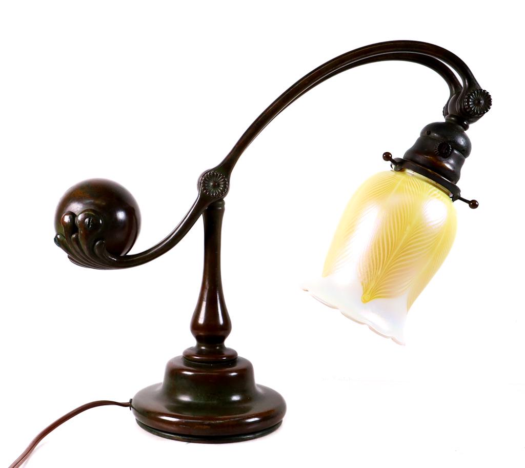 Tiffany Studios Counterbalance Lamp w/Quezal Shade: Early 20th century Tiffany Studios New York counterbalance bronze desk lamp having bronze adjustable body with ball balance, fitted with a Quezal shade. Shade signed Quezal. Underside of lamp stamped 