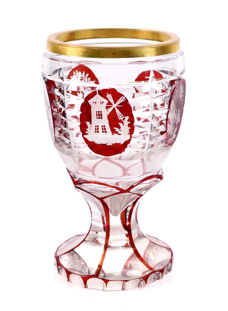 Bohemian Cut & Engraved Ruby Stained Goblet: Attributed to Moser, Bohemian colorless, faceted cut body, with ruby stained and engraved oval reserves gilt enamel rim and cut eight-panel stem and foot. Approx. height 5.25 in.
