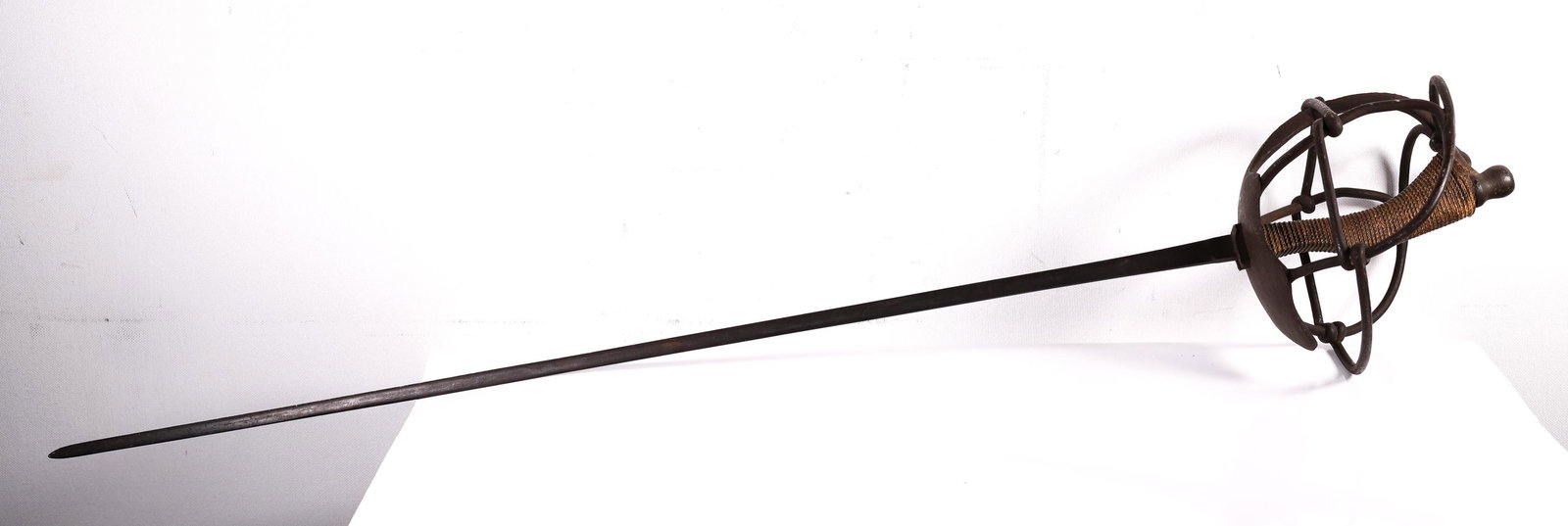 Unmarked Fencing Ã‰pÃ©e w/ Knotted Circular Hilt: Steel blade and hilt. Handle is wrapped in rope. Unmarked.Overall length: 38 inches. Blade measures 31 inches. Handle measures 7 inches.