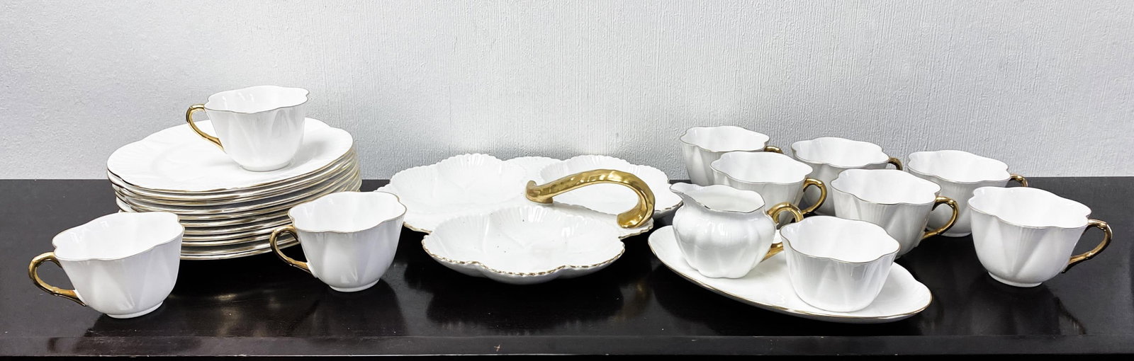 SHELLEY ENGLAND FINE BONE CHINA REGENCY PATTERN: Shelley England fine bone china in the Regency pattern with with gold trim comprising 9 snack plate and cup sets with two additional plates; tray with creamer and sugar; three-part relish dish with ha