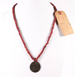 NORTH WEST COMPANY TOKEN WITH BEADED NECKLACE: On April 24th 1779 several Montreal based fur merchants joined forces to form the North West Company. Over the next 4 decades the conglomerate engaged in an intense competition with the Hudson's Bay C