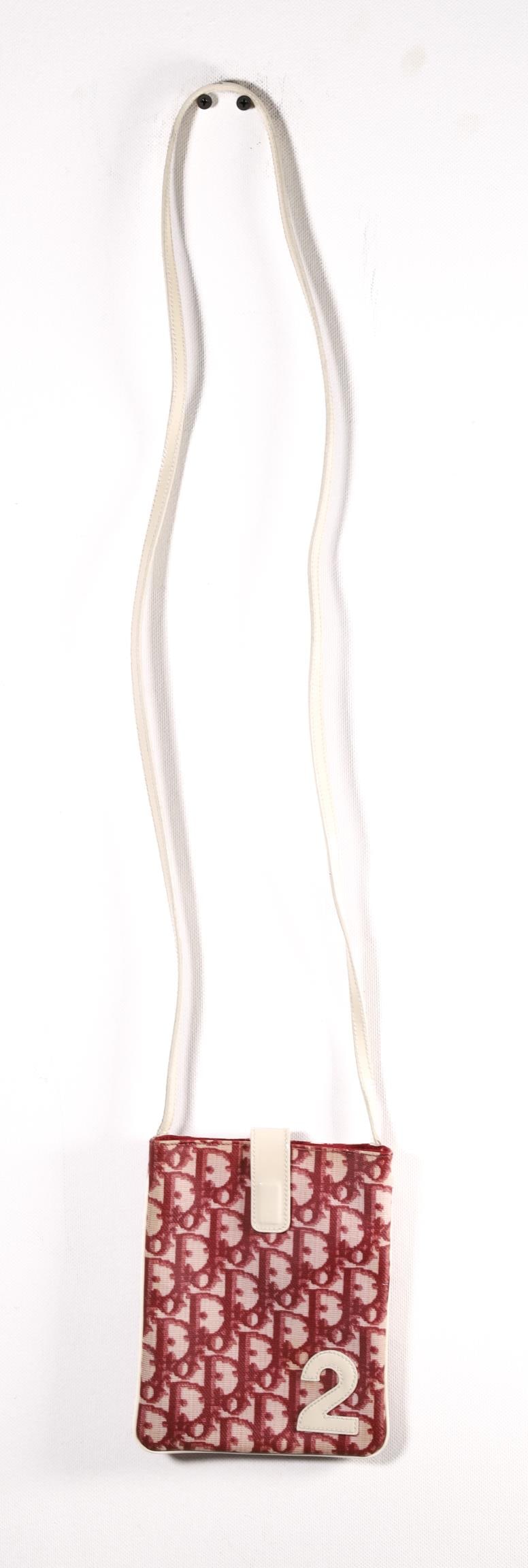 BURGUNDY DIORISSIMO MINI CROSSBODY BAG: From the spring 2002 collection by John Galliano for Christian Dior adorned with the iconic Diorissimo print and leather accents. Details and measurements: Length: 5 IN. / 12.6 CM. Height: 7 IN. / 17.