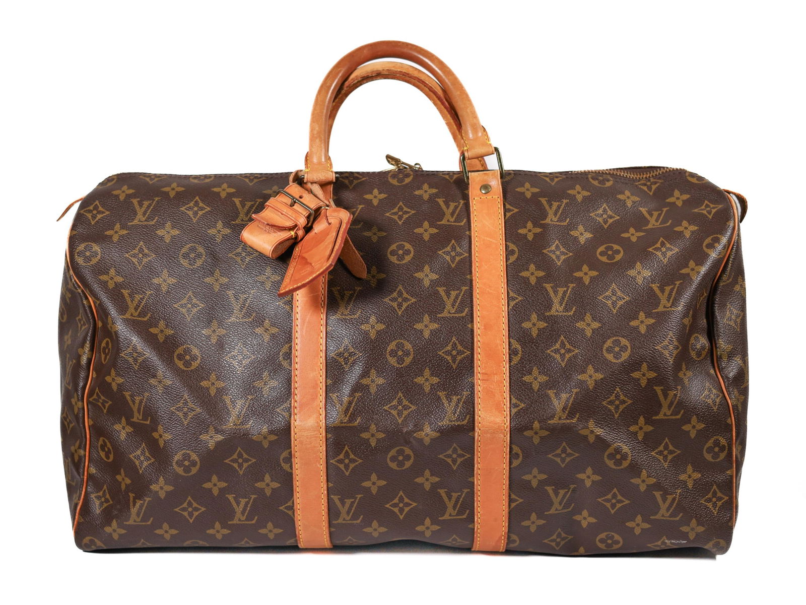LV KEEPALL 55 CANVAS TRAVEL BAG: The Keepall 55, named for its 55-centimeter length, offers a generous interior to accommodate all your travel essentials. It features a sturdy, double zipper closure, comfortable rolled leather handle