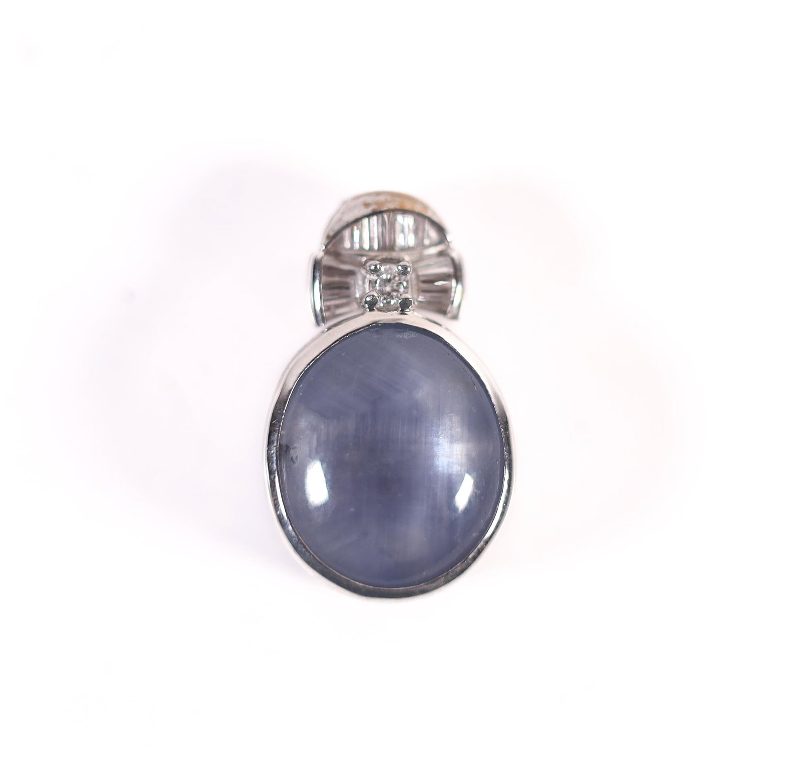 18KWG 11.96 STAR SAPPHIRE DIAMOND PENDANT: A gorgeous 18-karat white gold 11.96-carat star sapphire pendant accented by round-cut and tapered baguette diamonds. Stamped K18WG, D013, on the pendant's bail and 11.96 on the bottom of the pendant.