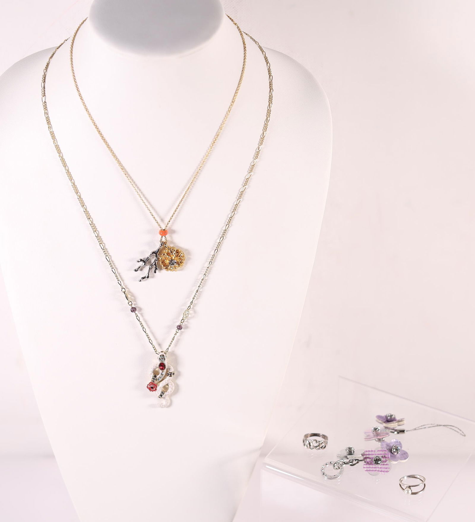 LOT OF 5 TIFFANY ETC. NECKLACES/RINGS: Two necklaces from Chloe and Anna Sui, a sterling silver ring from Tiffany & Co., a silver ring, and an Anteprima charm key chain. T&Co. ring stamped 925, Tiffany & Co., Elsa Peretti, on the inside of