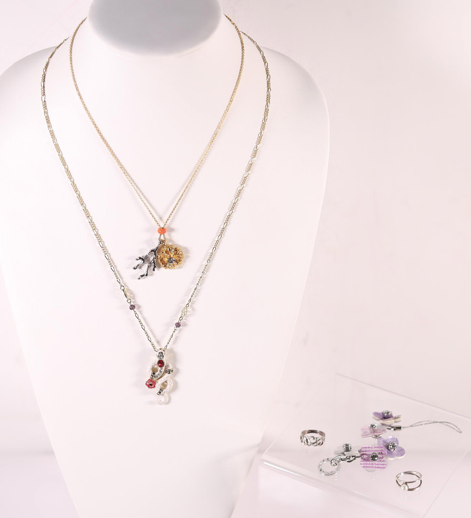 LOT OF 5 TIFFANY ETC. NECKLACES/RINGS: Two necklaces from Chloe and Anna Sui, a sterling silver ring from Tiffany & Co., a silver ring, and an Anteprima charm key chain. T&Co. ring stamped 925, Tiffany & Co., Elsa Peretti, on the inside of