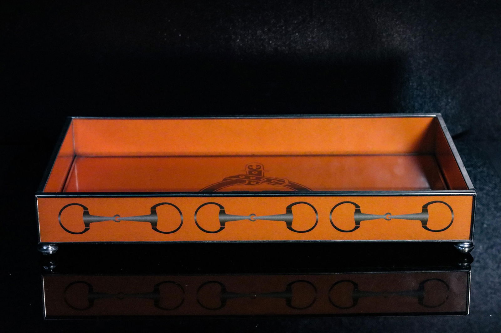 HERMES GLASS VALET TRAY: This is a Hermes glass Valet tray with a silver over bronze structure. It has an orange color and features the signature Hermes 'H' on the center of the tray. Details and measurements: Dimensions: 6.5