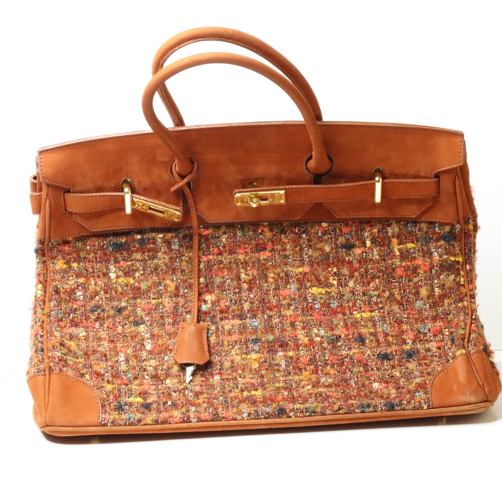 LEATHER & TWEED HANDBAG: Ingeborg tweed tote bag in good condition. Designed to look like an Hermes Birkin bag and made of top shelf materials. It features gold-toned hardware, handles, four feet, leather trim, and a tweed pa