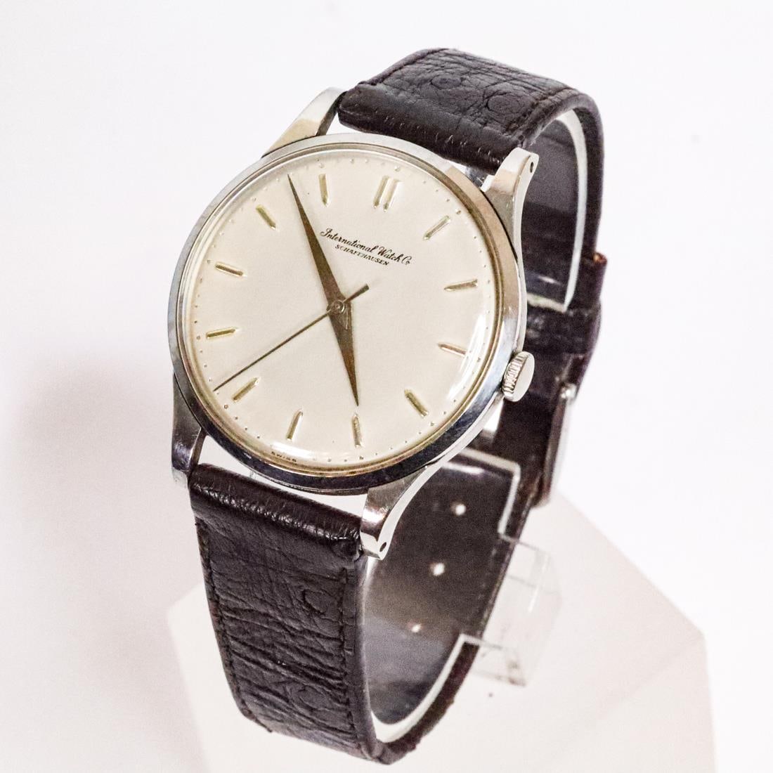 VTG IWC SCHAFFHAUSEN STAINLESS STEEL WATCH, 32MM: Vintage IWC Schaffhausen watch in good condition. It features a silver-toned dial, a stainless steel case, and a black leather band. IWC represents the pinnacle of German Bauhaus design in watches, wi
