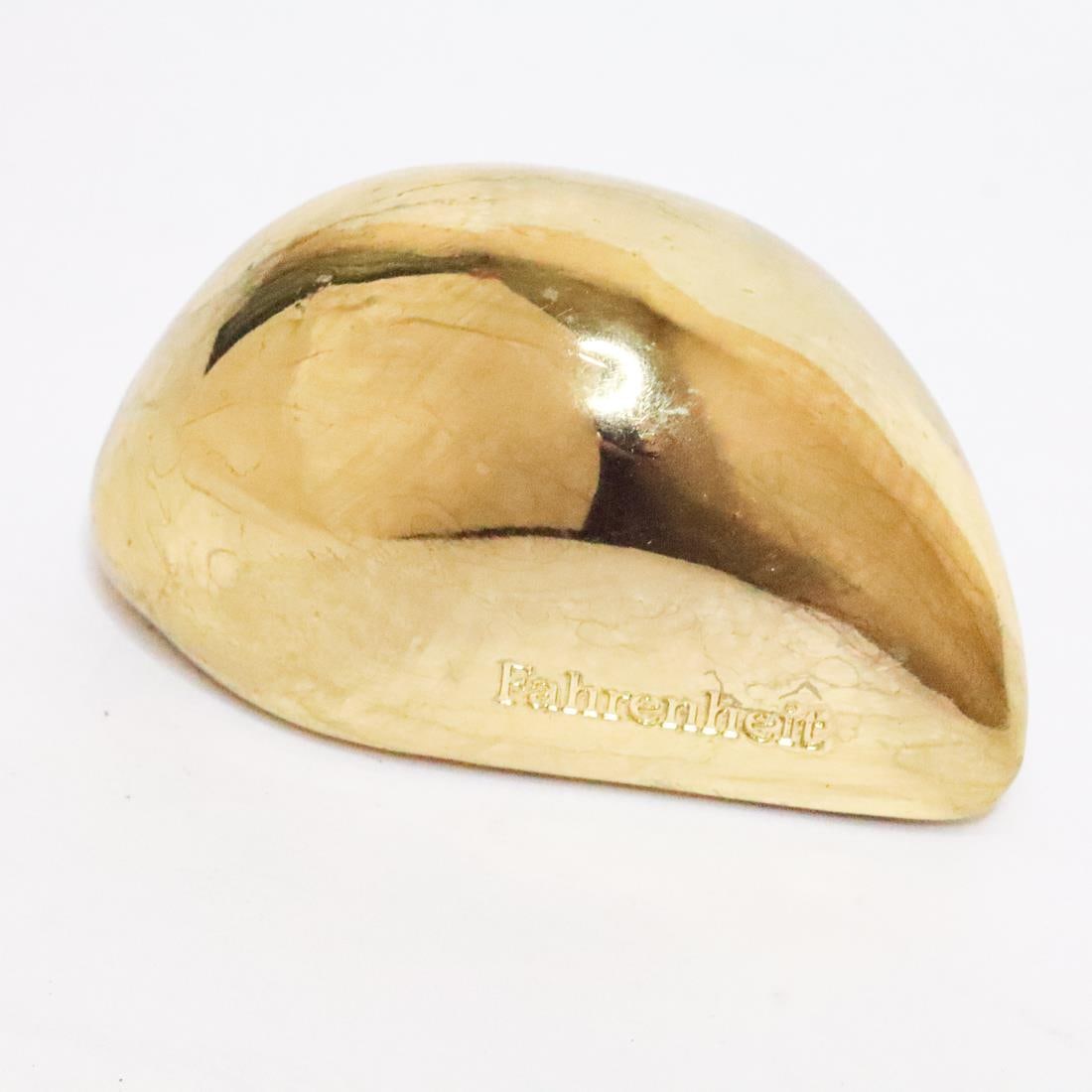 CHRISTIAN DIOR GOLD-PLATED PAPERWEIGHT: Christian Dior gold-plated paperweight. Stamped 1989.3.18, Christian Dior, on the bottom of the paperweight and Fahrenheit on the side. Details and measurements: Weight: 351.2 G.