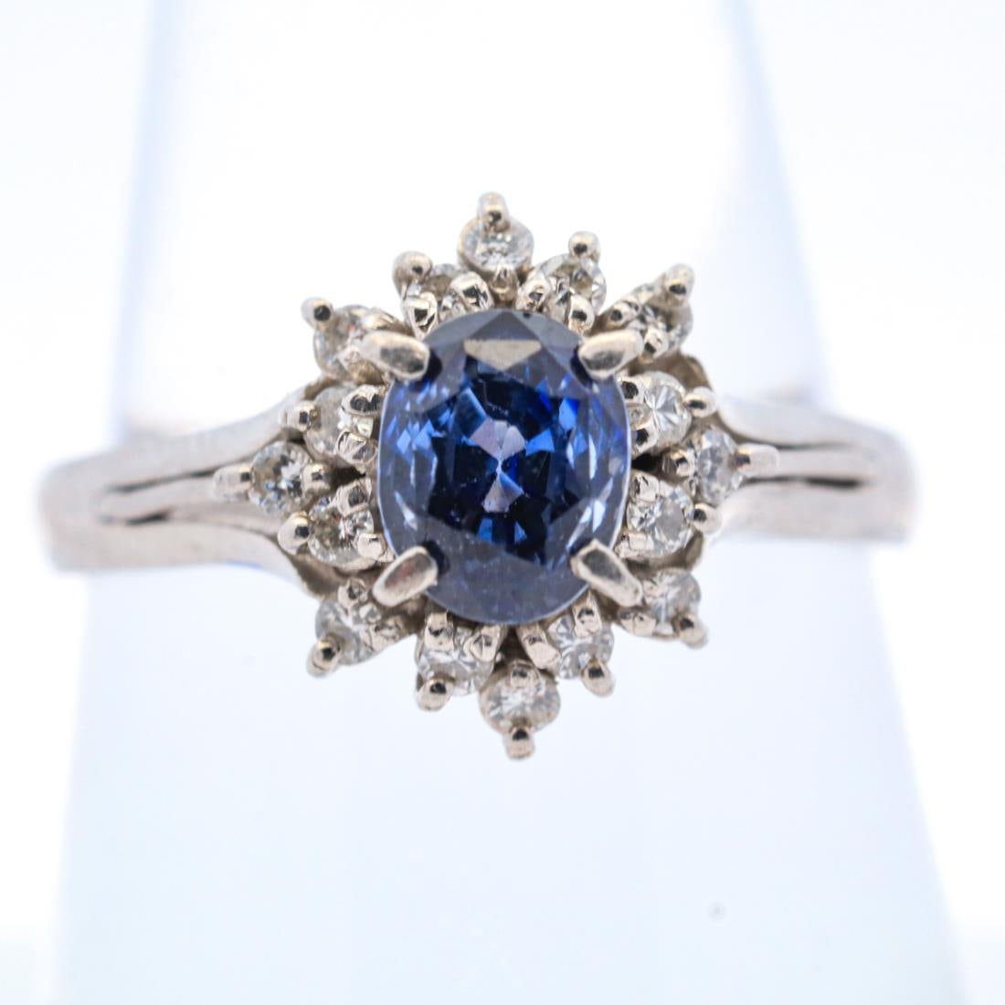 900PT 1.69CTTW SAPPHIRE & DIAMOND HALO RING, 7.25: 900-purity platinum ring with a 1.47-carat oval-cut sapphire center stone accented by a halo of round brilliant diamonds totaling 0.22 carats. Stamped 022, 147, Pt900, on the inside of the ring band. 