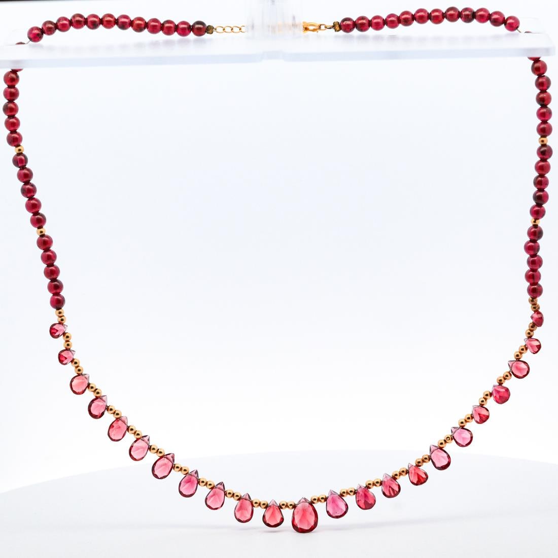18KYG BEADED GARNET NECKLACE: 18-karat yellow gold beaded red garnet necklace. Stamped K18 on the necklace's clasp. Details and measurements: Necklace length: 17.5 IN. Weight: 13.7 G.