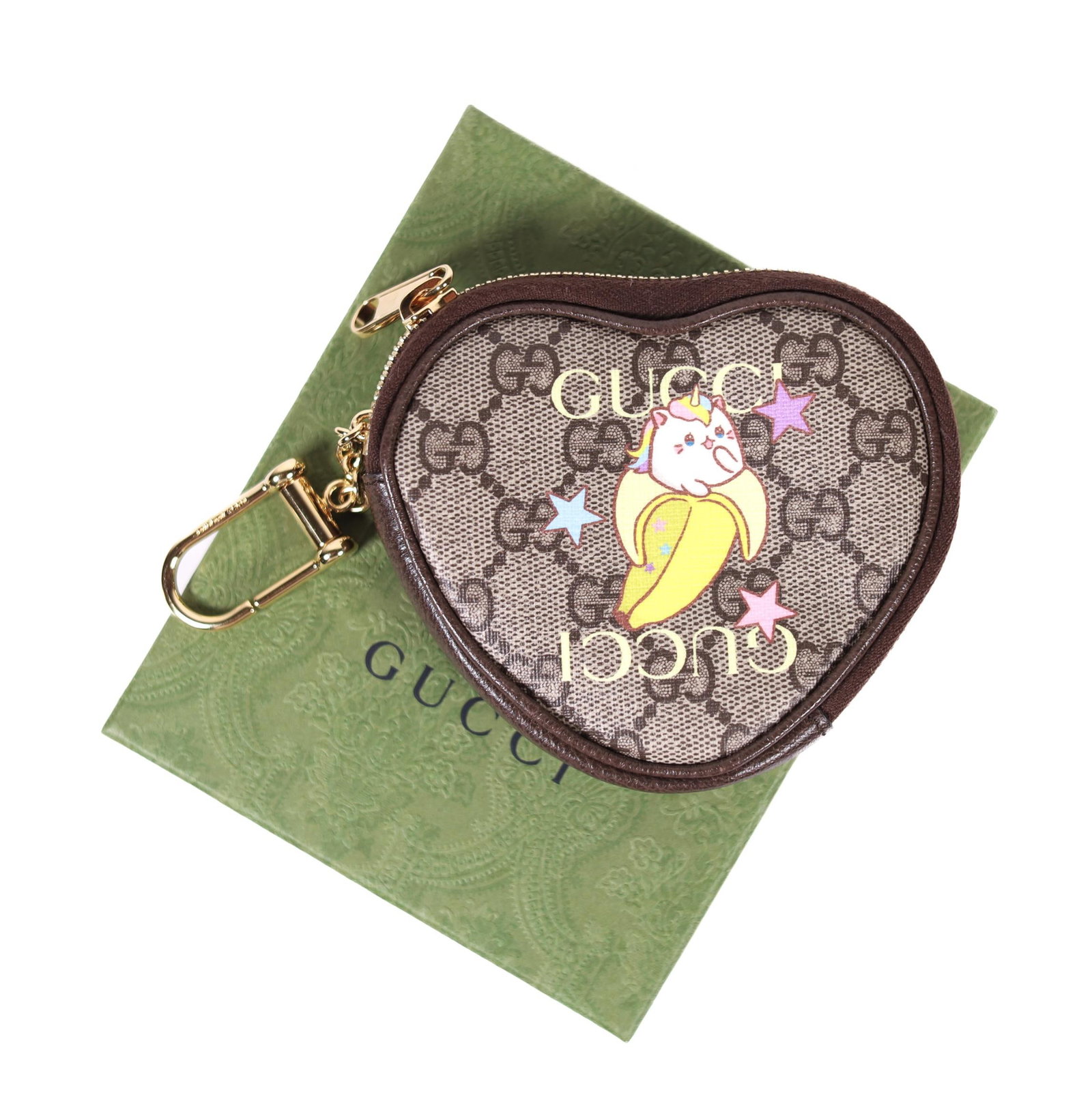 GUCCI HEART SHAPE PORTA MONETE W/BOX: Heart-shaped Gucci coin porta monete. This pouch features leather trim, the signature Gucci monogram, and a Bananya design. It has minor wear but is still in excellent condition. The pouch is lined wi