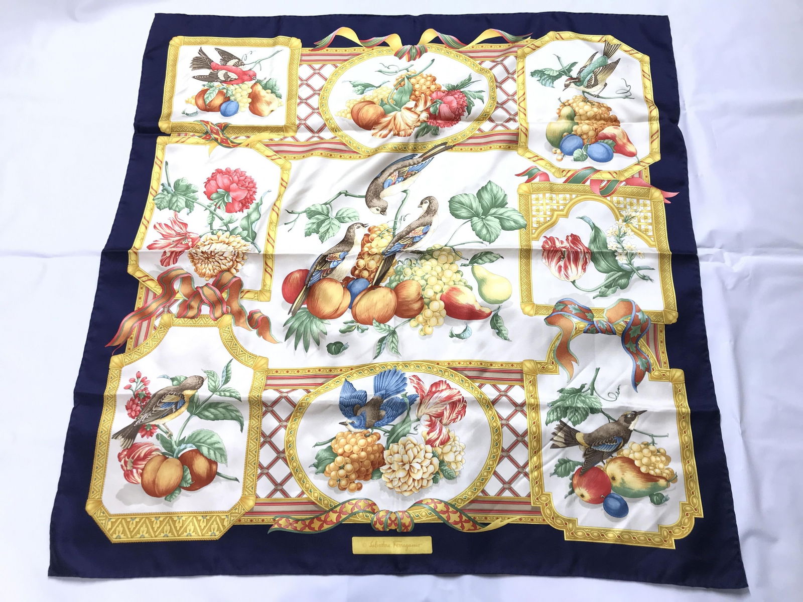 SALVATORE FERRAGAMO BIRD & FRUIT MOTIF SCARF: This is a Salvatore Ferragamo bird and fruit motif scarf in excellent condition. Details and measurements: Dimensions: 34 IN. X 34 IN.