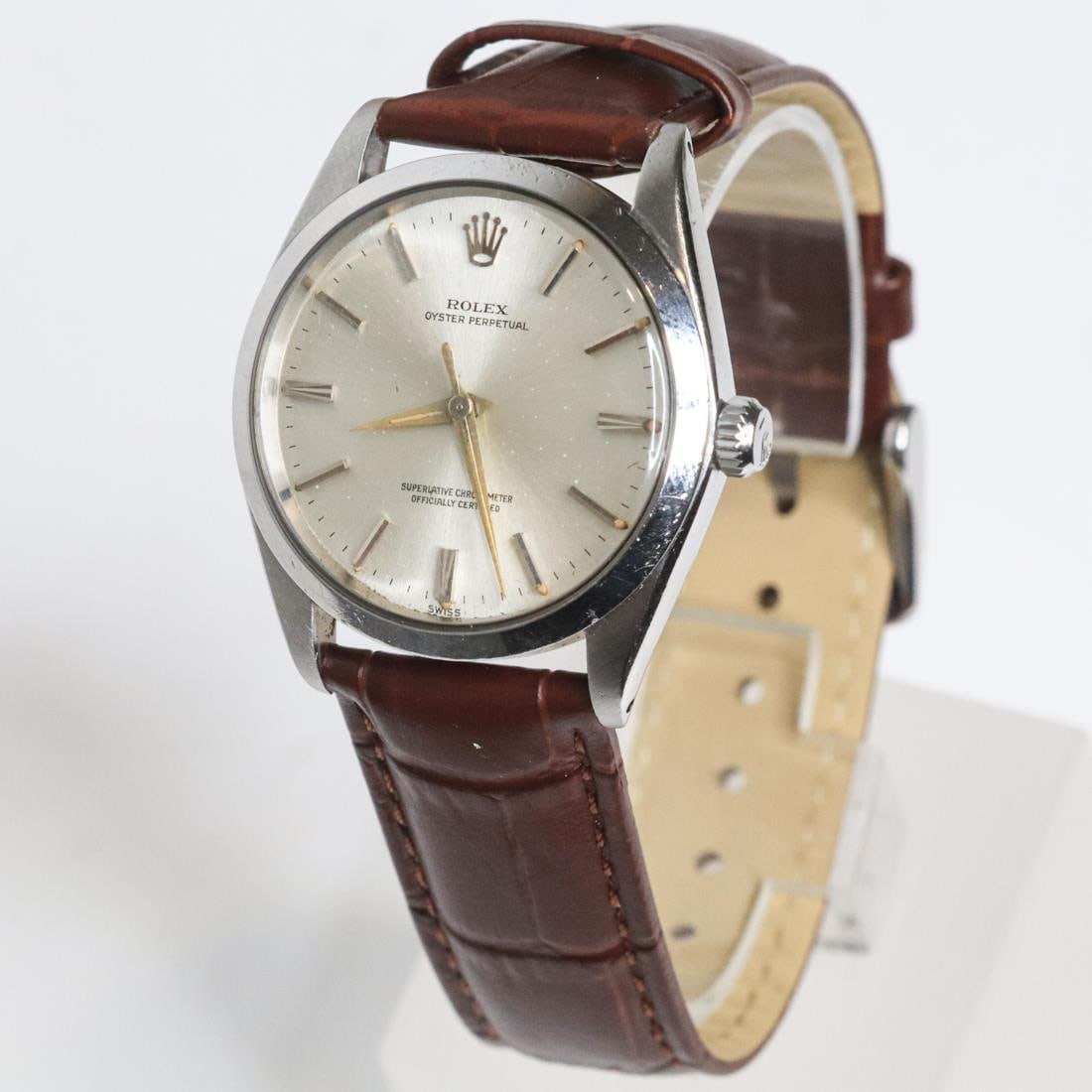ROLEX OYSTER PERPETUAL 1002 WATCH W/BOX, 34MM: Rolex Oyster Perpetual 1002 watch serviced 9/24. It features a silver-toned dial, a stainless steel case, and a brown leather band. It comes with a box Stamped Rolex Oyster Perpetual, Superlative Chro