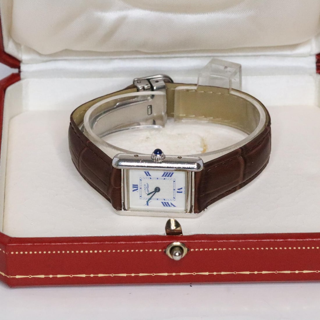 CARTIER TANK STERLING 2416 WATCH W/BOX, 22MM: Cartier Tank sterling silver 2416 watch in excellent condition. It features a sterling silver case, a white dial, a brown leather band, and a stainless steel clasp. It comes with a box. Stamped Must d