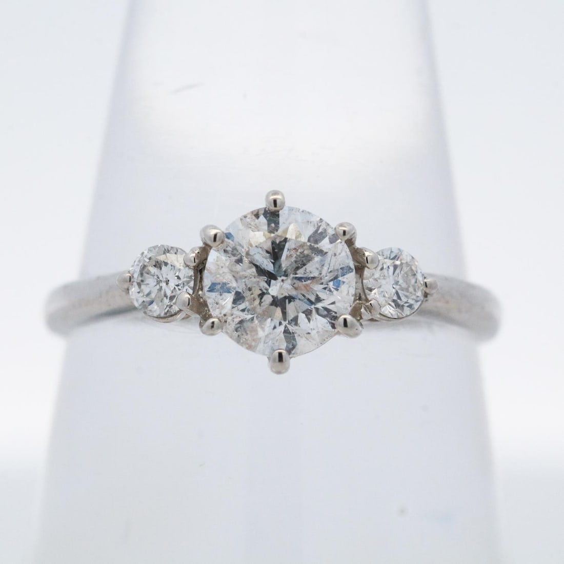 PLATINUM 1.057CTTW DIAMOND RING, SIZE 6: 1000 platinum ring featuring a 0.857-carat round brilliant diamond center stone accented by 0.20 carats of round brilliant diamonds. Marked Pt1000, 0.857, 0.2. Details and measurements: Ring size: 6. 