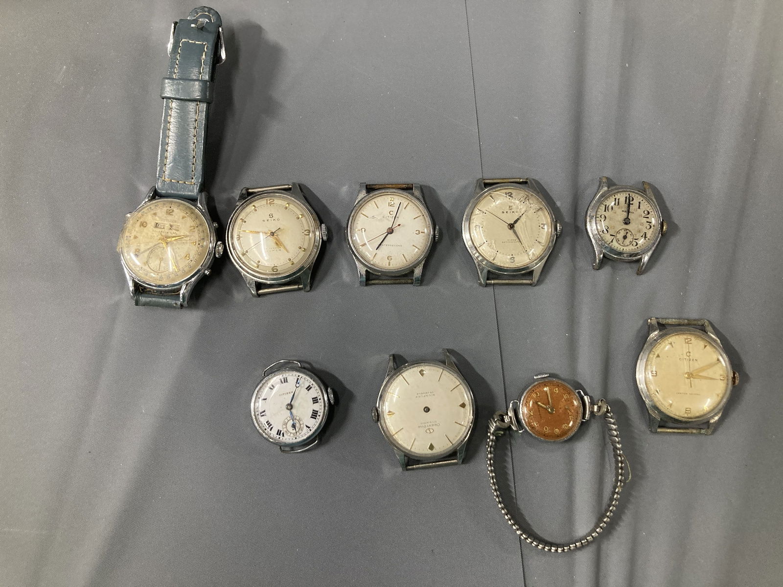 Vintage Japanese Wristwatch Lot – Seiko, Citizen, and Others (9 Watches, Mid-Century Mechanical): An early post-war collection of Japanese mechanical wristwatches, circa 1940s–1960s, comprising Seiko, Citizen, and various unbranded examples. These represent the early evolution of Japan’s domes