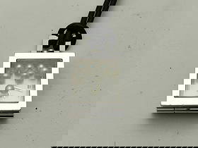 Mikimoto Necklace Watch Quartz Pearl: authentic mikimoto quartz necklace watch with floating pearl detail inside a square stainless steel case. the face opens to reveal a minimalist analog dial marked “mikimoto.” features a cluste