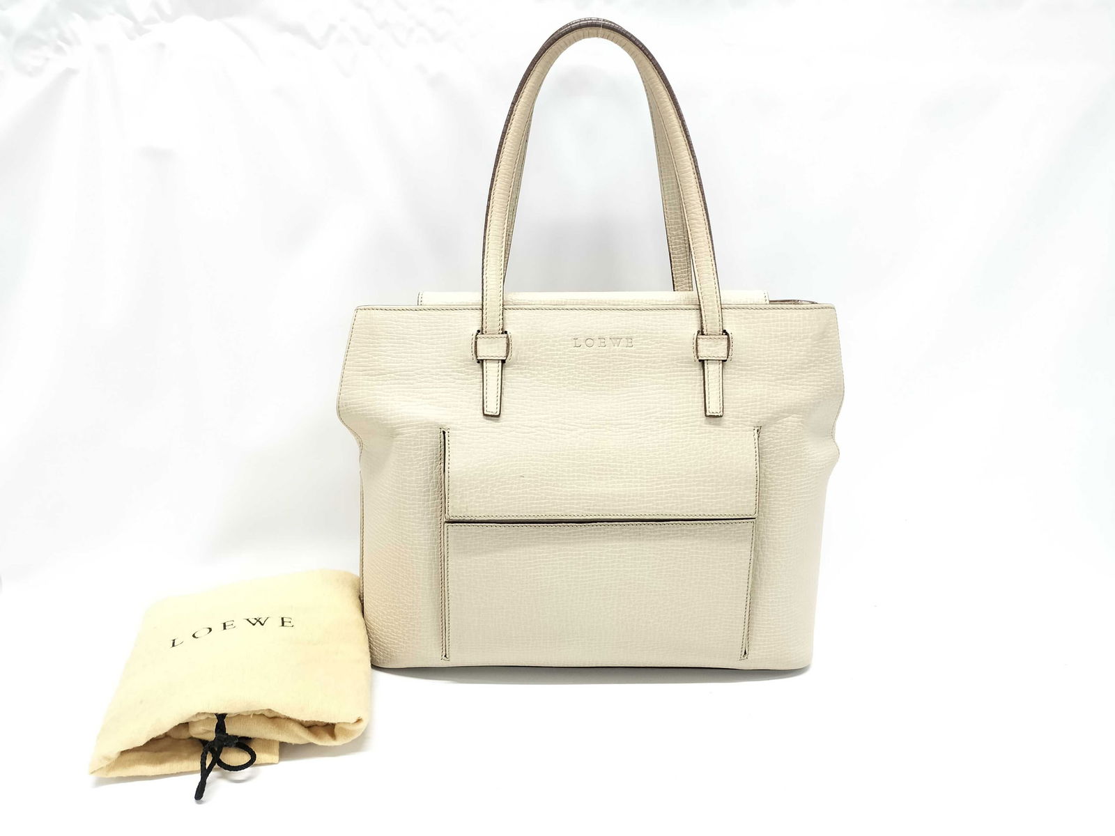 Loewe Leather Hand Bag in Cream: Loewe Leather Hand Bag in Cream. This top strap tote bag is by the hottest brand of the year, Loewe. If you have a daughter, she is looking for this bag. I assure you this is a very popular bag that a
