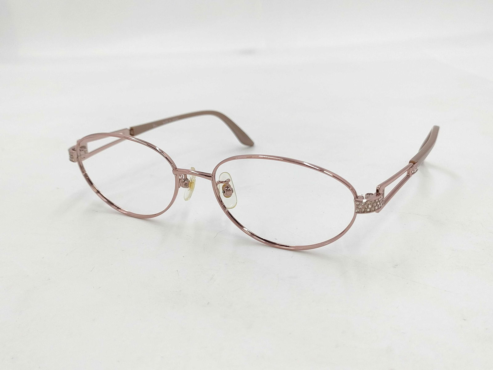 Christian Dior Pink Glasses Frames Eyewear Lightweight: Authentic Christian Dior eyeglasses featuring slim pink-tone metal oval frames with engraved temple accents. Adjustable nose pads and coated arm tips for comfort. Light surface scratches and minor scu
