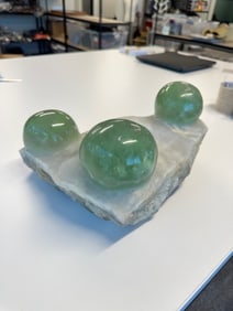 Polished Jasper Ovoids on White Quartz Substrate