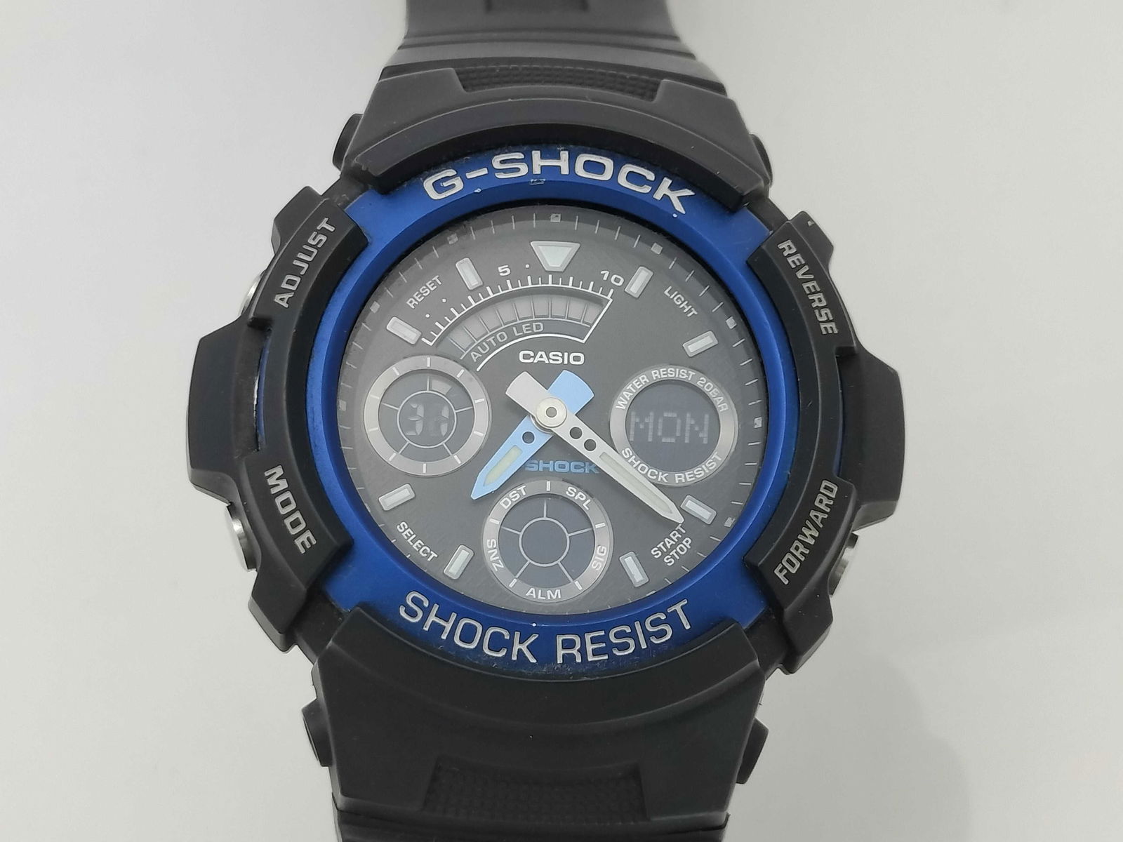 Casio G-Shock AW-591 Blue & Black Boys’ Watch: Casio g-shock aw-591 boys’ watch, authentic. black resin case and strap with blue metallic bezel and stainless steel caseback. analog-digital hybrid display with three sub-dials showing stopwatch, d