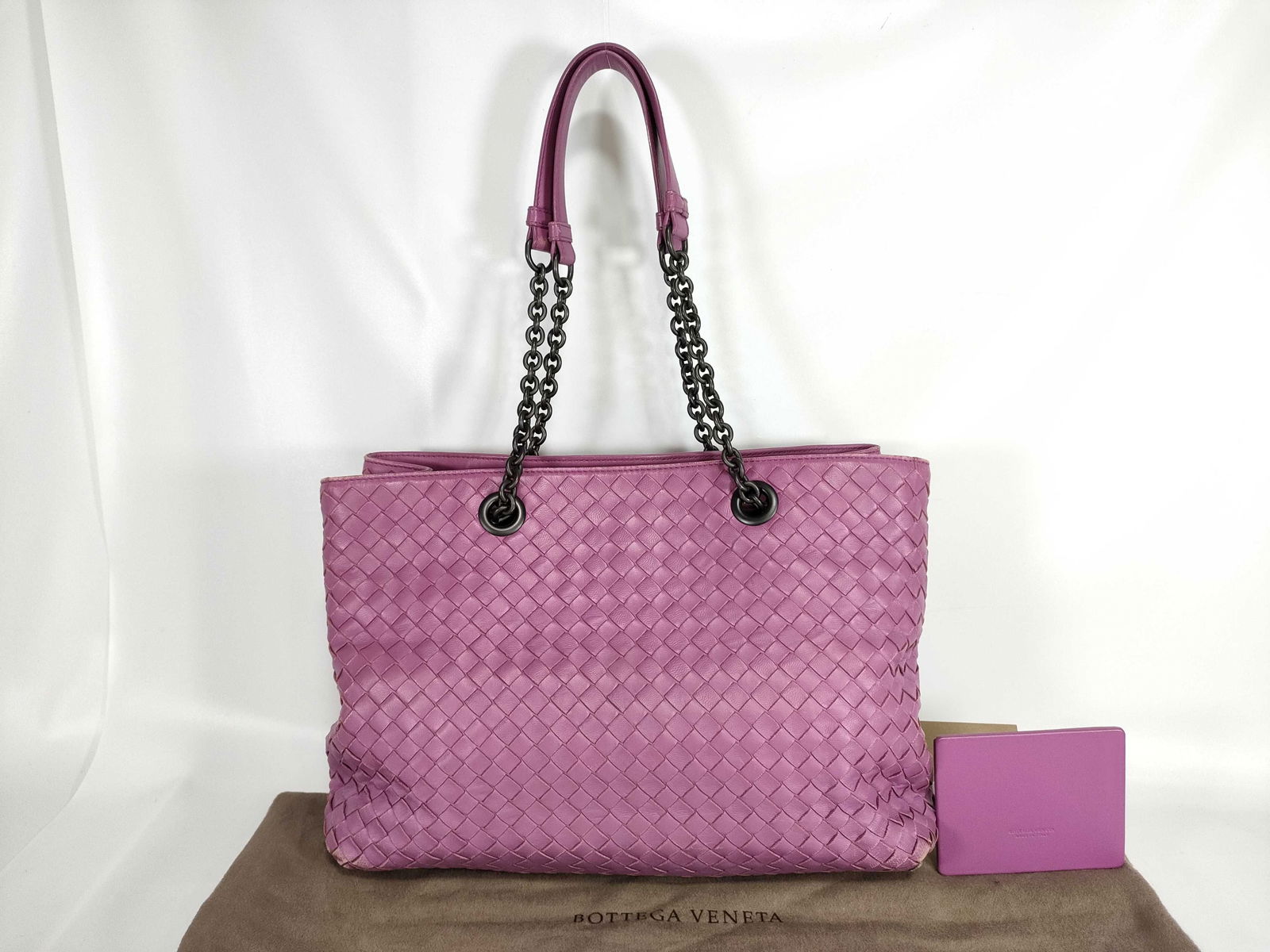 Bottega Veneta Intrecciato Chain Tote Bag in mauve: Bottega Veneta tote bag having rectangular structured body constructed from mauve leather woven in signature Intrecciato pattern across front, back, and sides. Weave presenting tight, uniform strips c