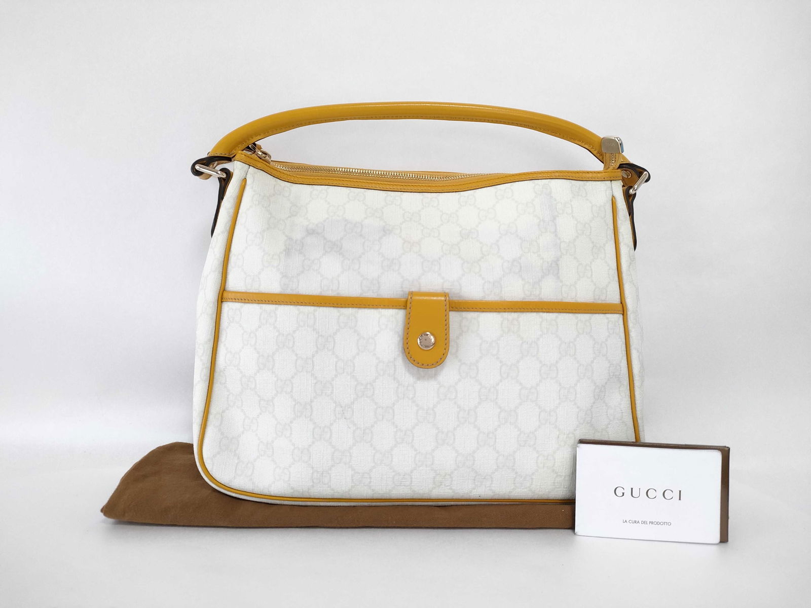 GUCCI GG Plus Joy Handbag in White: Authentic Gucci GG Supreme hobo shoulder bag in white coated canvas with light yellow leather trim and silver-tone hardware. Features a single adjustable shoulder strap, zip-top closure, and a front s