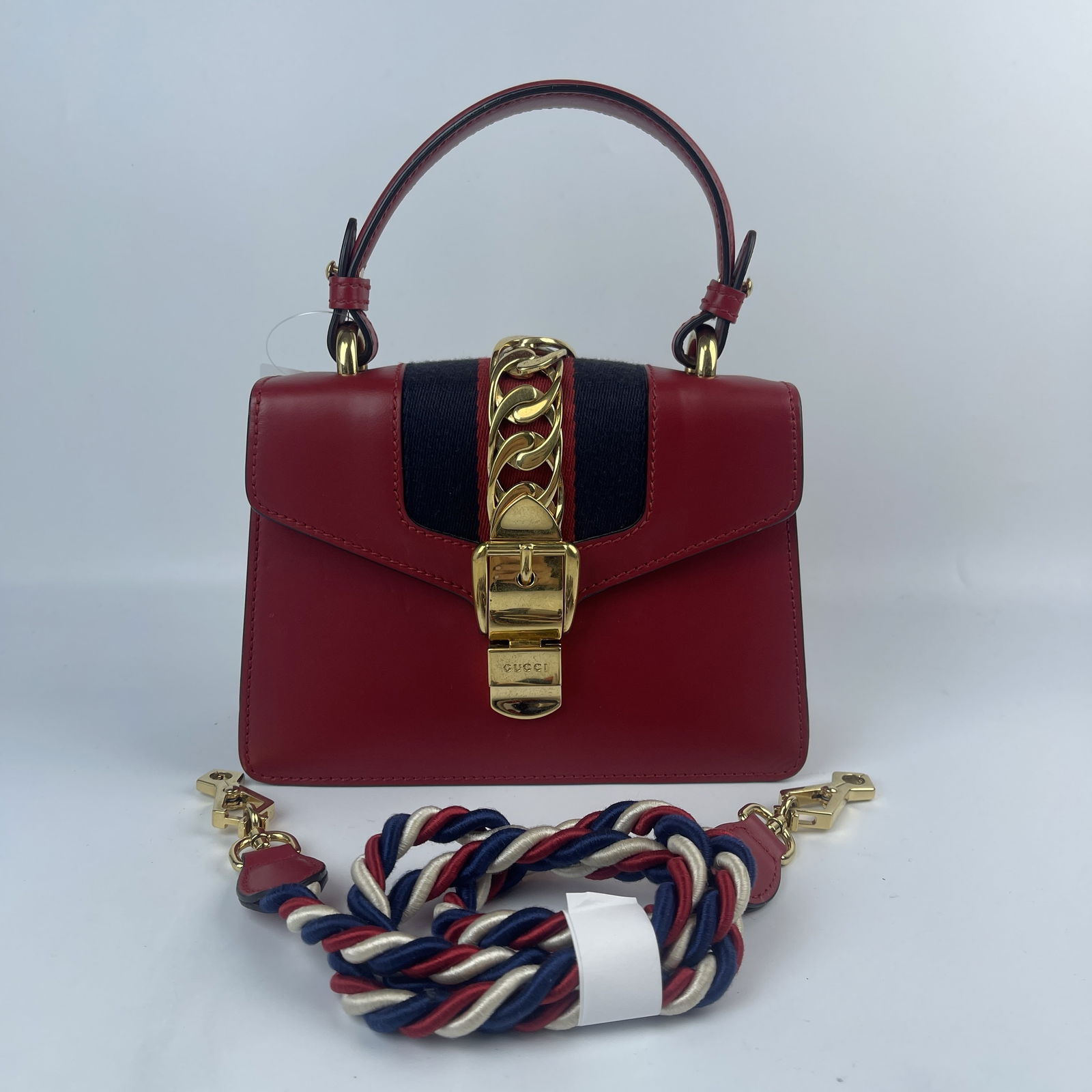 Gucci Sylvie 2 Way Shoulder and Handle bag 470270: Authentic Gucci Sylvie 2 Way Shoulder and Handle bag 470270. Red leather and gold hardware, includes top handle and shoulder strap in tri color braided yarn. 
