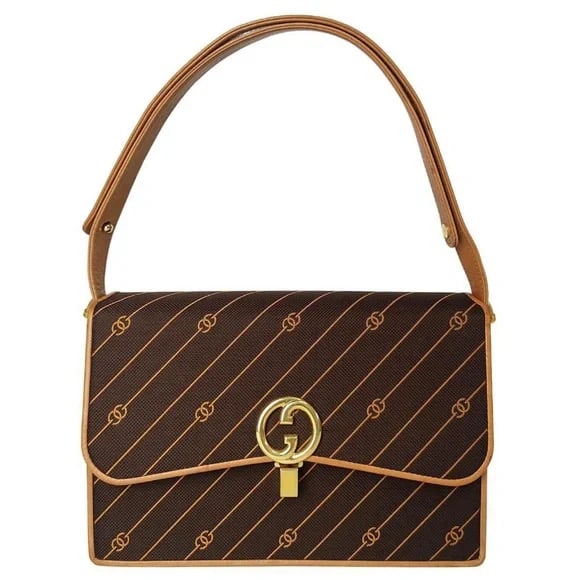 Vintage 60s Gucci Shoulder Bag that contains the spirit of a girl at the height of it all: Authentic vintage Gucci brown grosgrain-type canvas shoulder bag with an embroidered logo and beige leather trim. Very good condition especially considering age. Some scuffing to interior of the bag's